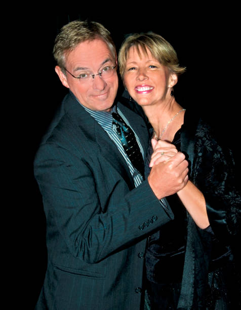 istock Older couple dressed up dancing with black background 1300224658