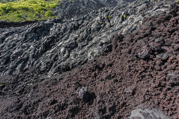 Pahoehoe, is basaltic lava that has a smooth, billowy, undulating, or ropy surface. Aa lava has arough surface and is broken into pieces. Hawaii Volcanoes National Park, Hawaii, The Big Island.