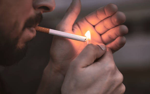 istock Close up young man smoking a cigarette. 1300226696