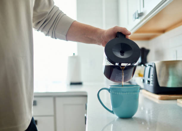 istock Unrecognizable male filling coffee mug with coffee 1300229083