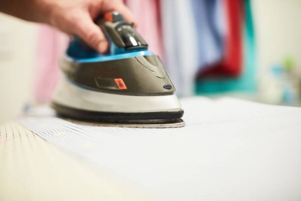 istock Unrecognizable male ironing a shirt in a home laundry room 1300229828