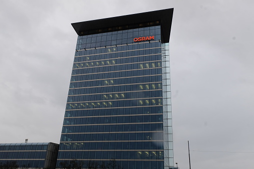 Munich, Bavaria Germany - February 3 2021: Osram Licht AG global german corporation headquarters building red logo. Specializations in high-tech photonics and sensor technology.