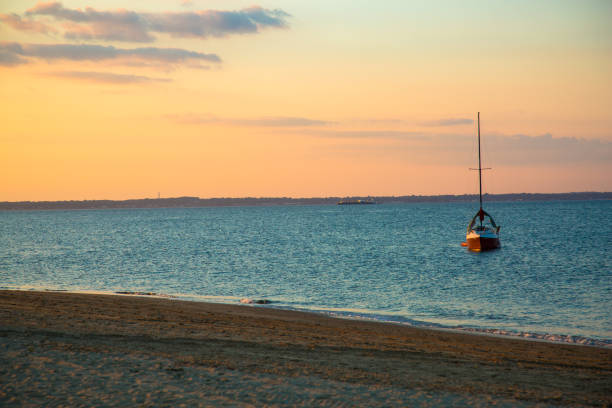 istock Sunset and a Sailboat in the Sea 1300230770