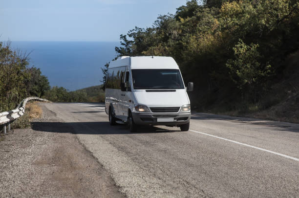 istock Minibus Moves on the road from the sea 1300231289