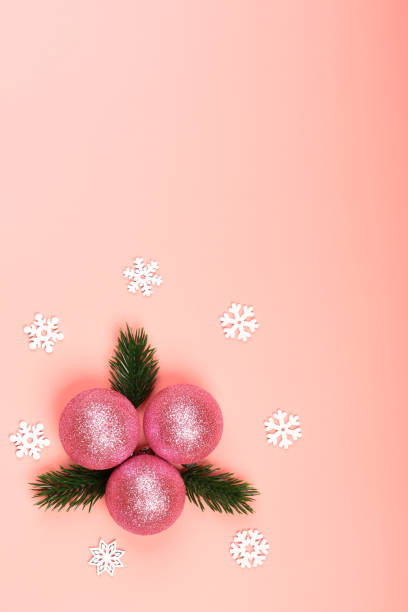 istock Creative christmas minimalistic composition. Christmas ball on a pink background. pink glitter christmas toy with christmas tree branches. top view, flat style, empty place for text 1300232180