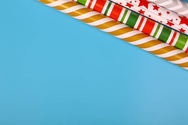 istock gift wrapping paper on a blue background. minimalistic christmas scandy background with empty place for text. top view, flat style 1300233158