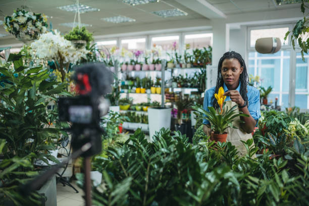 istock Young woman vlogging in greehouse 1300233401