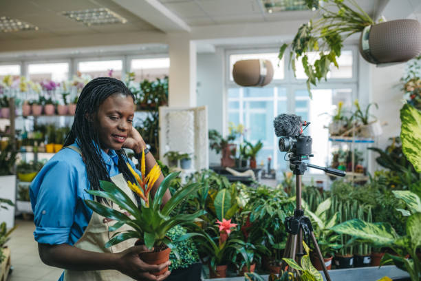 istock Young woman vlogging in greehouse 1300233948