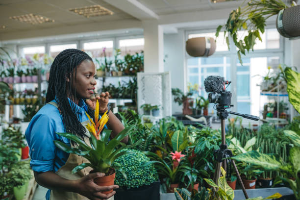 istock Young woman vlogging in greehouse 1300233996