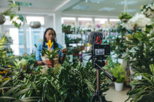 istock Young woman vlogging in greehouse 1300234019