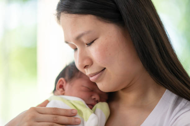 istock Mother snuggling newborn baby 1300234291