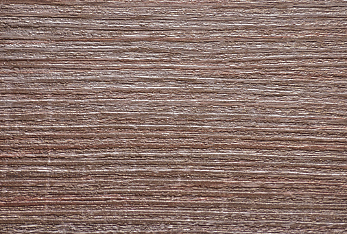 Dark walnut with a bright rich natural pattern close-up. Background, pattern, texture.