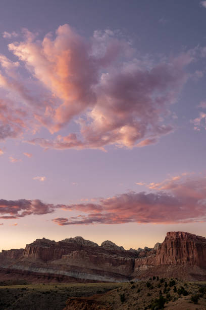 istock Cotton Candy Clouds Hang Over Rock Formations In Capitol Reef 1300238609
