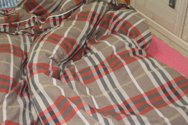 istock Crumpled white bedclothes top view 1300238803