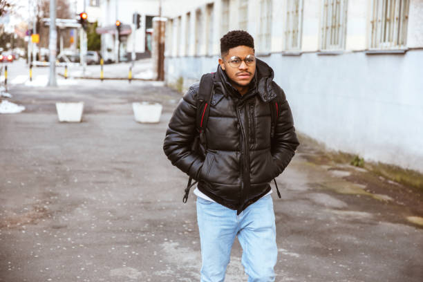istock Young Afro-American student walking on the street 1300240351