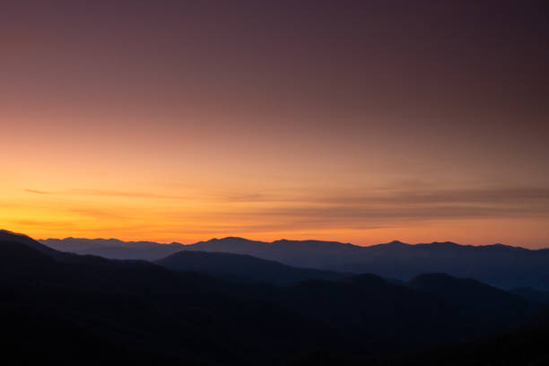 istock Purple Sky Lights Over Silhouetted Mountains 1300242070