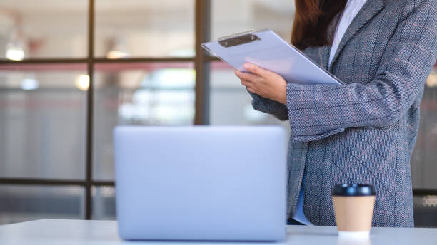 istock a business woman using laptop computer while working on paperwork in office 1300244050