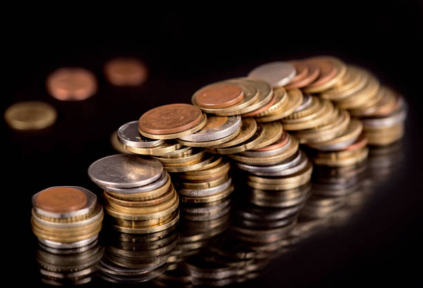 istock Stacks cf different country coins on black 1300244195
