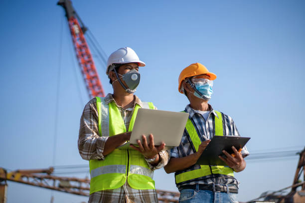 istock Two Asian construction workers working on construction sites that are critical to an industry supervised construction. construction worker concept 1300250859
