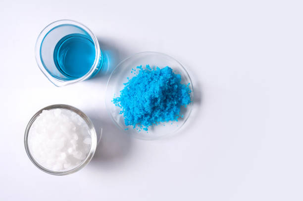 istock Inorganic chemical on white laboratory table. Copper(II) sulfate, Microcrystalline wax, alcohol. Chemical ingredient for Cosmetics and Toiletries product. Top View 1300253553