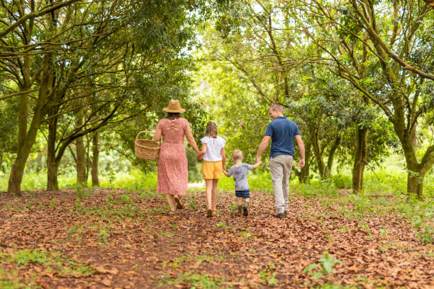 istock Family Walking Together in a Macadamia Nut Orchard 1300255240