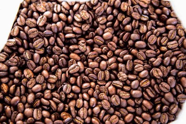 Coffee beans texture or coffee beans background. Brown roasted coffee beans. Closeup shot of coffee beans. Many coffee beans. Coffee beans can be used as a background