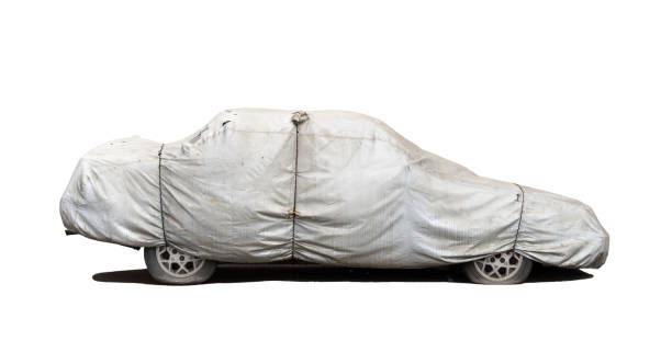 istock Car parked under gray cover 1300258595