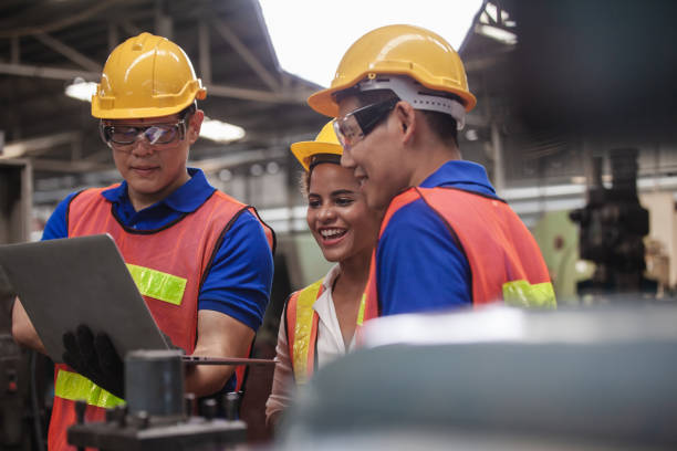 istock worker Industrial Engineers Talk with Factory Worker while Using Laptop. industrial worker is working. technician engineer and mentor checking process. machine metalworking industry concept copyspace 1300259648