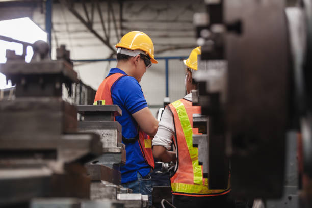 istock worker Industrial Engineers Talk with Factory Worker while Using Laptop. industrial worker is working. technician engineer and mentor checking process. machine metalworking industry concept copyspace 1300259886