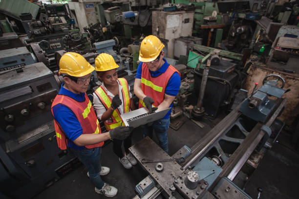 istock worker Industrial Engineers Talk with Factory Worker while Using Laptop. industrial worker is working. technician engineer and mentor checking process. machine metalworking industry concept copyspace 1300259964