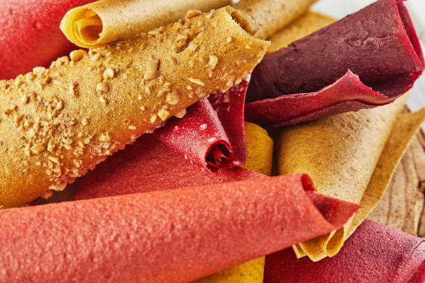 istock Sweet pure fruit pastille in rolls. Healthy sweets - lozenges, fruit chips. Natural sweets from berries and fruits. Diet vitamin food and vegan food 1300262204