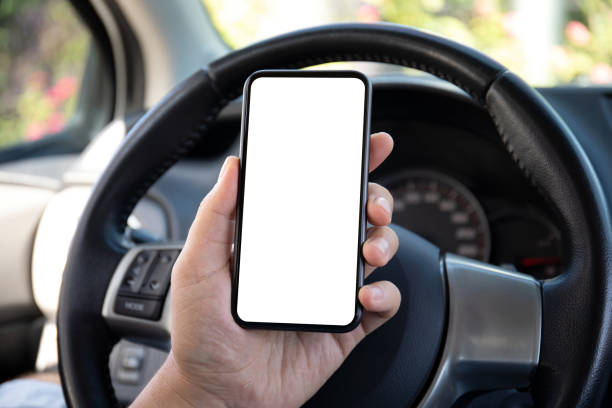 istock male hand holding phone with isolated screen in car 1300263276