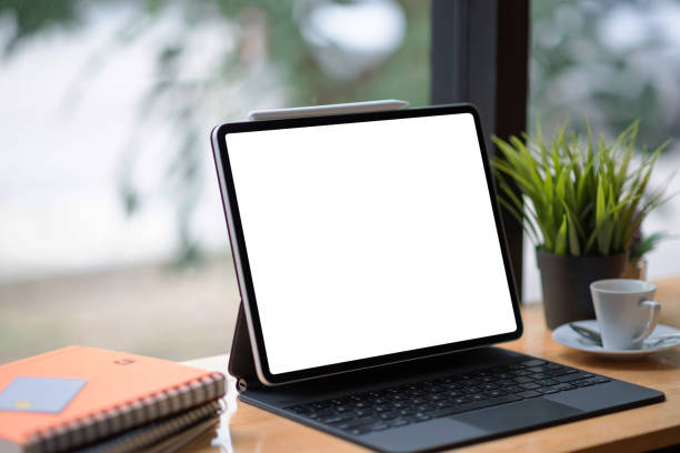 istock Nice table to put with a digital tablet at  coffee shop. Mock up. Blank white screen. 1300265008