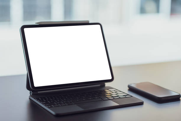 istock Digital tablet with blank screen on black table in office. Mock up. 1300265014