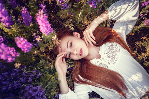 istock beautiful woman on purple background. spring sunset 1300265129