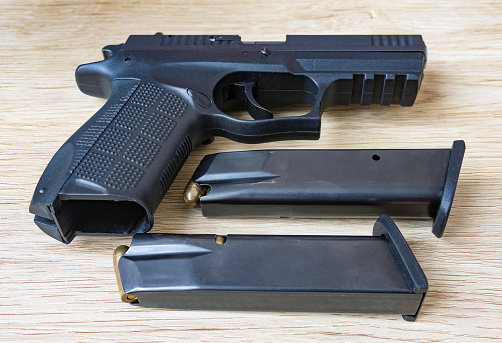 A loaded pistol magazines and semi automatic black 9mm gun.