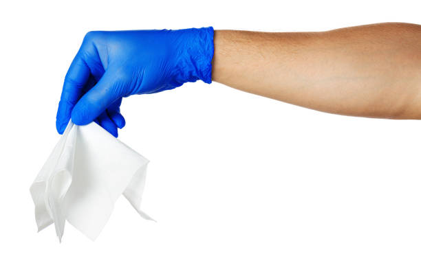 istock Hand with blue gloves takes a white cloth 1300267275