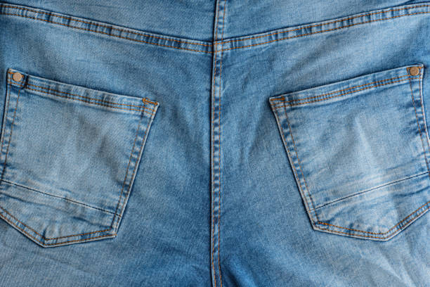 Back of classic jeans. Denim fabric. Yoke, back Pockets Back of classic jeans. Denim fabric. Yoke, back Pockets. yoke stock pictures, royalty-free photos & images