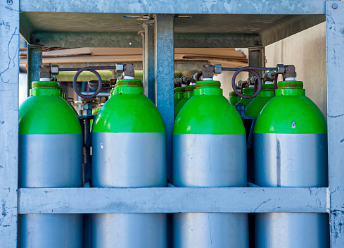 Gas industry, oxygen cylinders and pipes with valves.