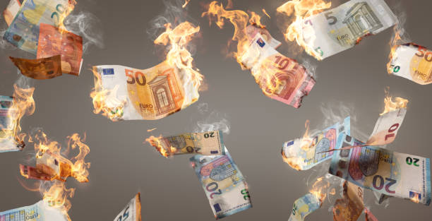 Burning Euro banknotes falling down Multiple Euro banknotes on fire falling down. Isolated on a neutral background. burning stock pictures, royalty-free photos & images