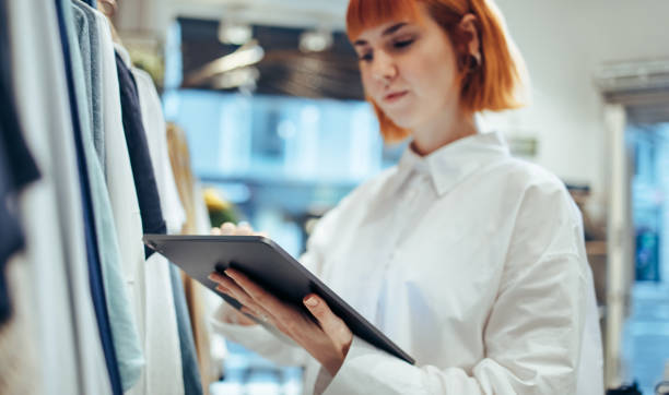 istock Businesswoman using digital tablet in her clothing store 1300271482