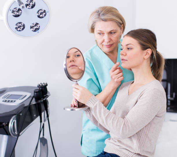 istock Cosmetologist consulting young woman 1300272296