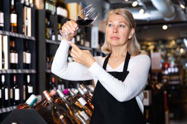 istock Ordinary female winemaker holding glass of wine 1300275617