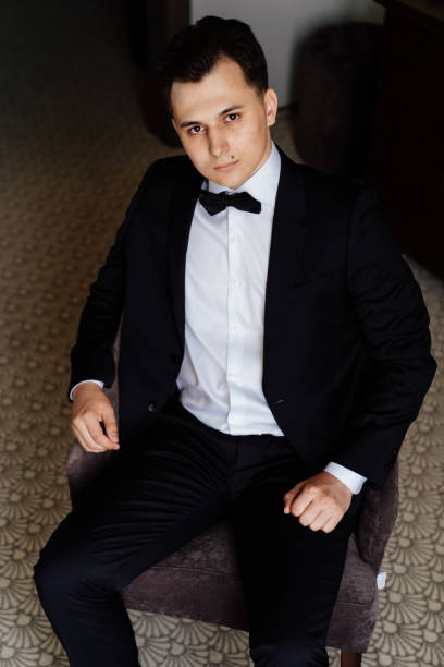 istock young man in white shirt, bow tie and a black jacket . 1300277730