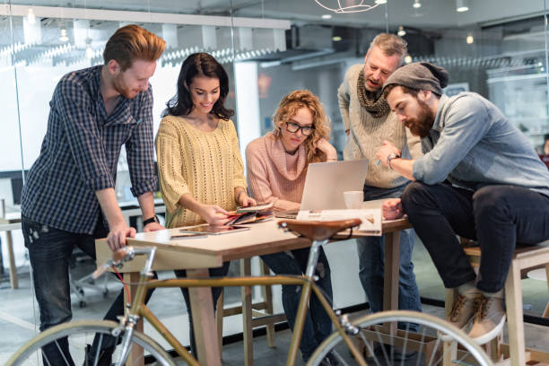 istock Multi-tasking freelance workers on a meeting in the office. 1300278926