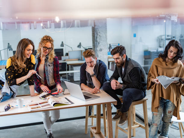 istock Young multi-tasking freelancers working at casual office. 1300279290