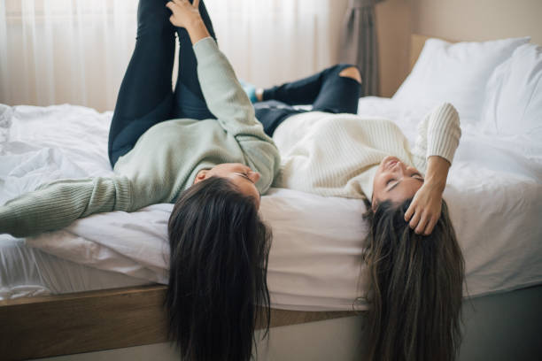 istock Two young women friends sharing happy time together 1300280108