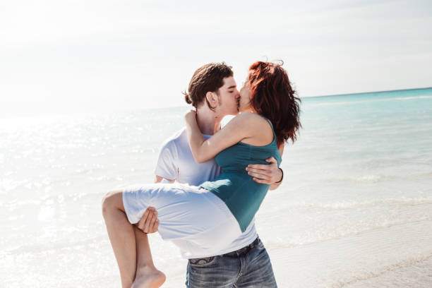 istock couple embracing at the beach 1300281661