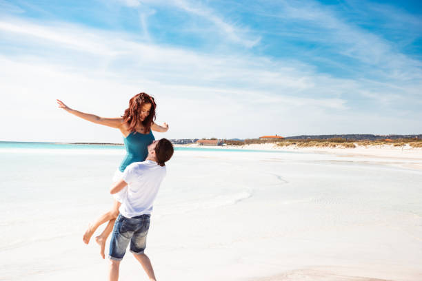 istock couple embracing at the beach 1300281926
