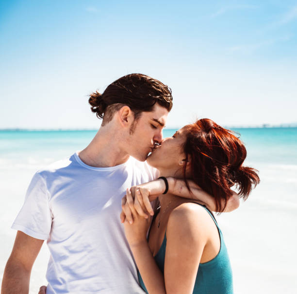 istock couple embracing at the beach 1300282086